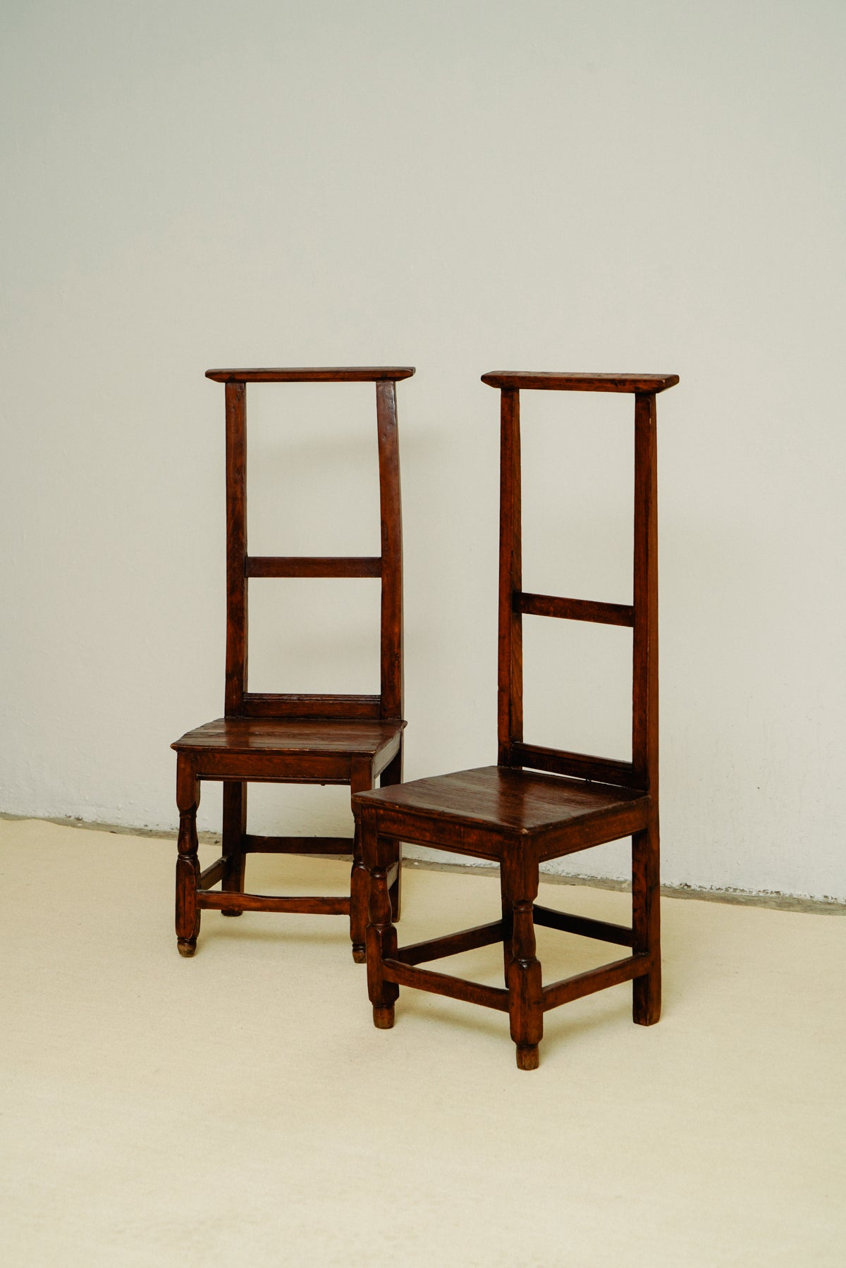 Small wooden chairs with high back rest
