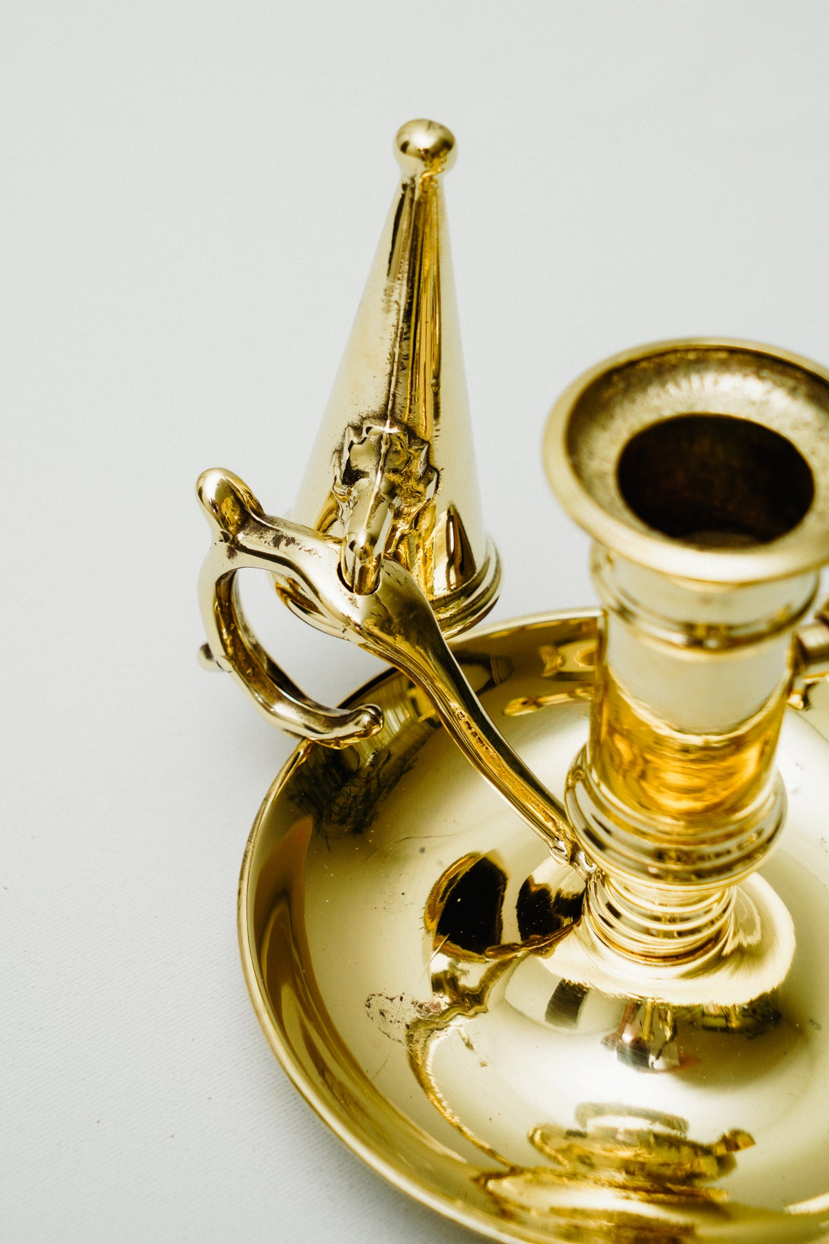 Brass candleholder with candle snuffer