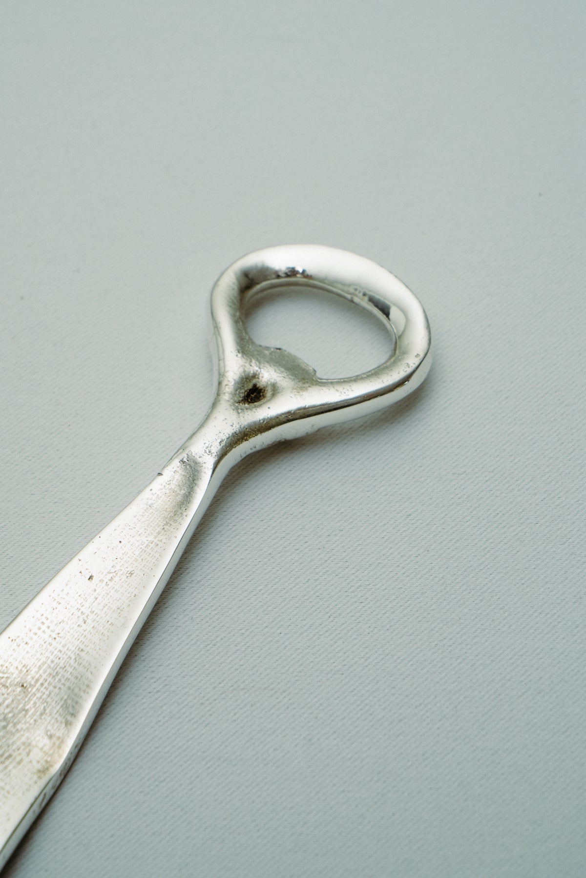 Tie bottle opener