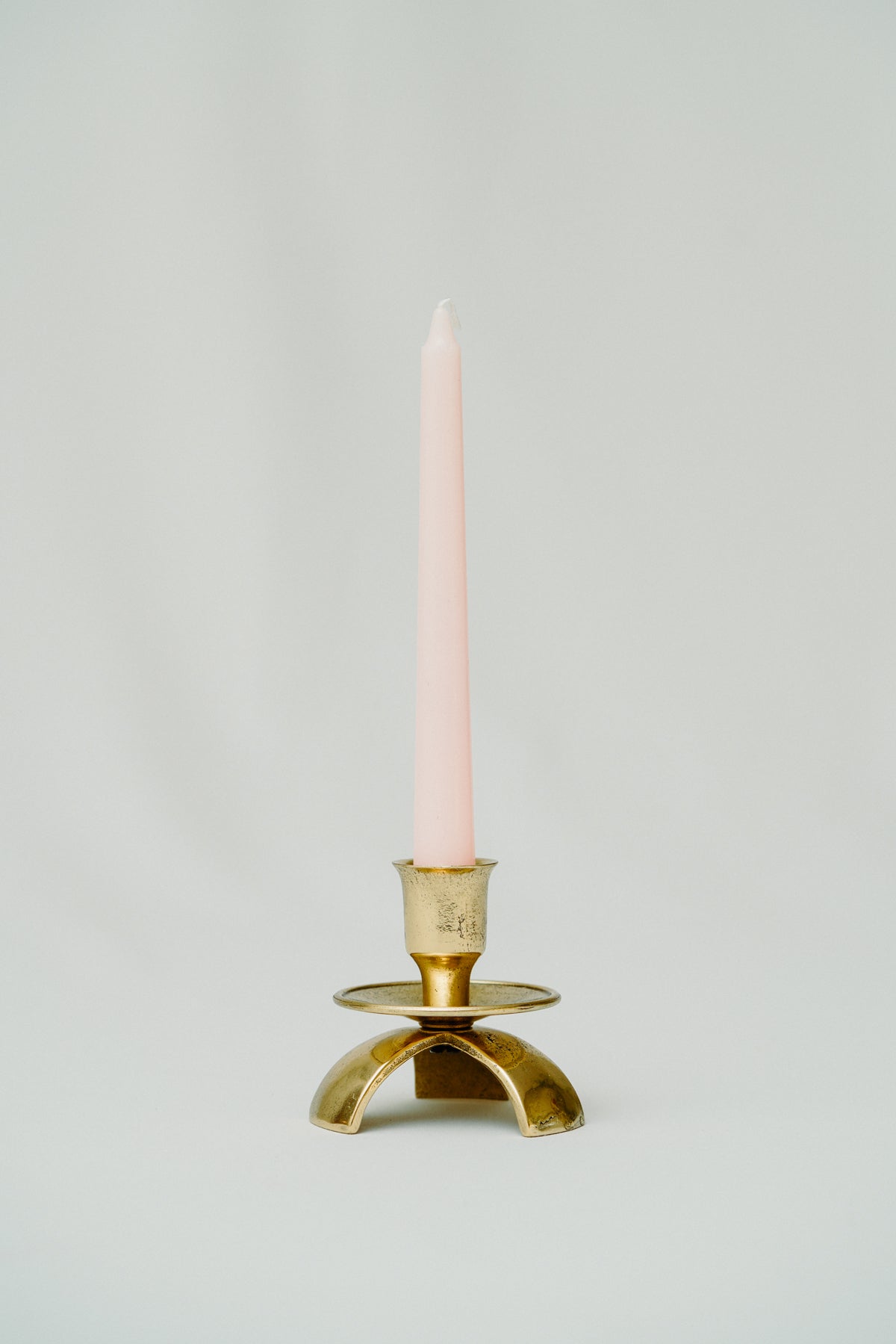 Three legged brass candle holder