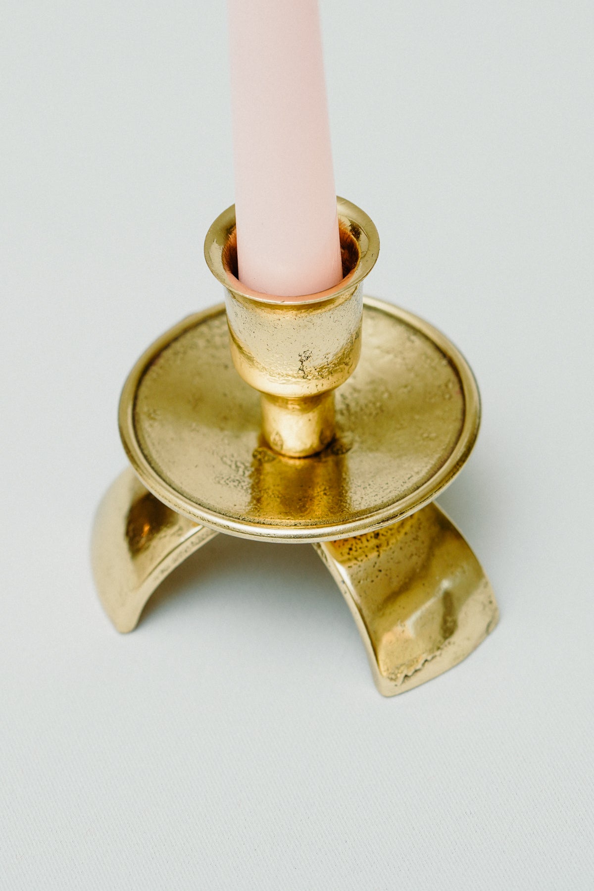 Three legged brass candle holder