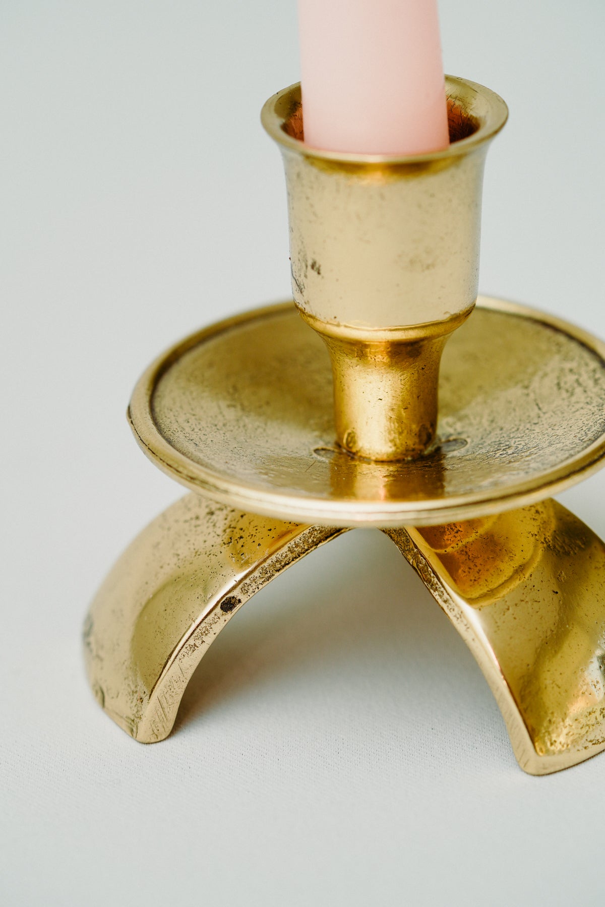 Three legged brass candle holder