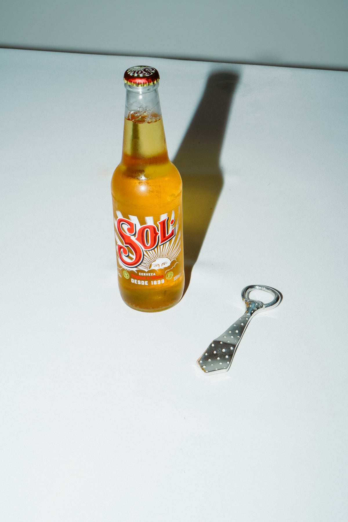 Tie bottle opener