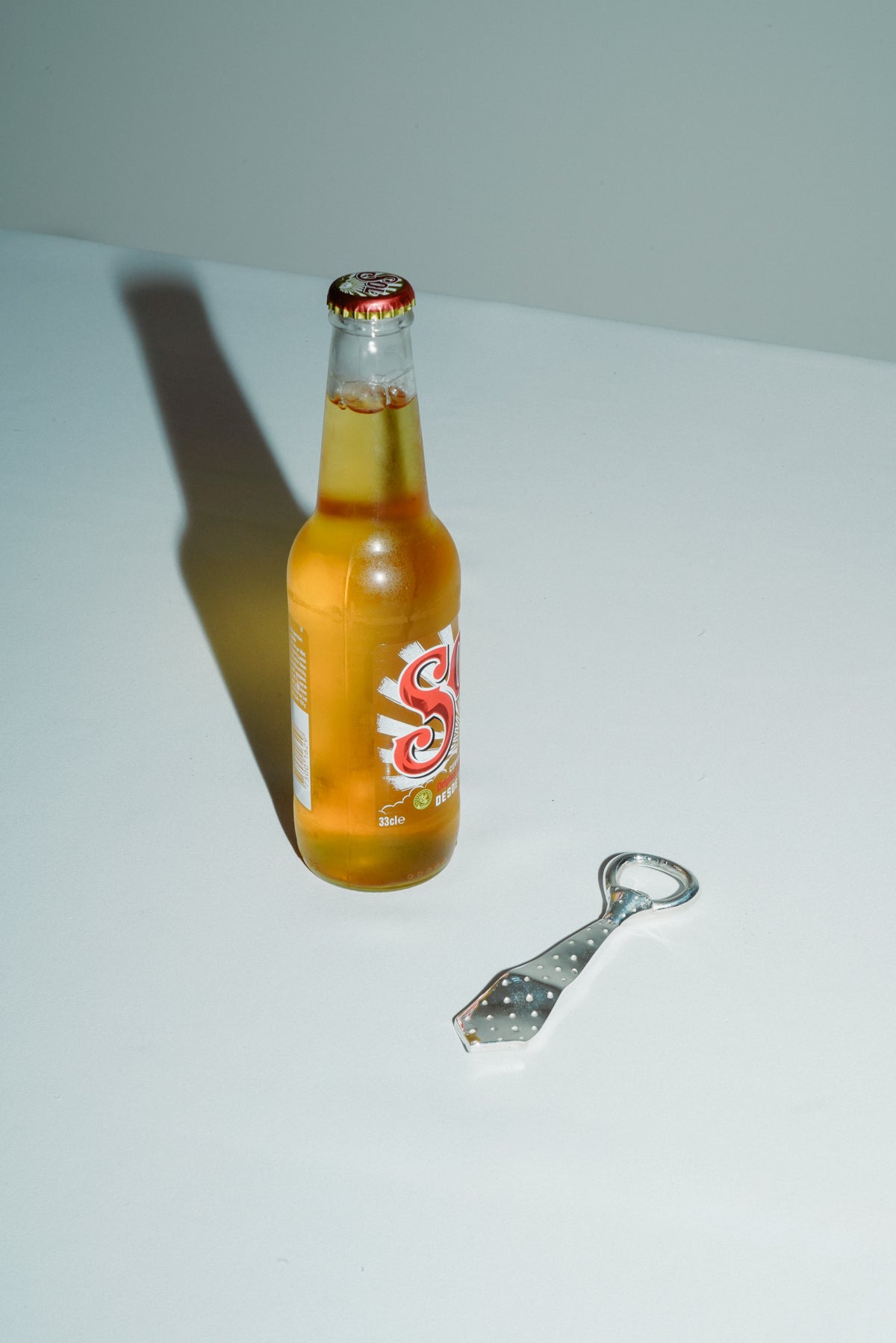 Tie bottle opener